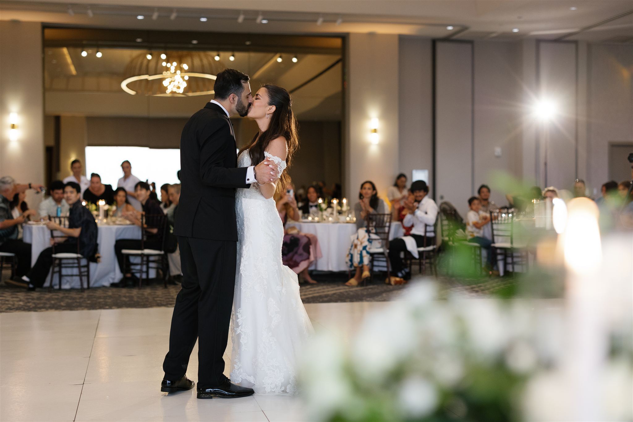 a couple sharing a first dance together and kissing at Ritz-Carlton O'ahu, Turtle Bay 