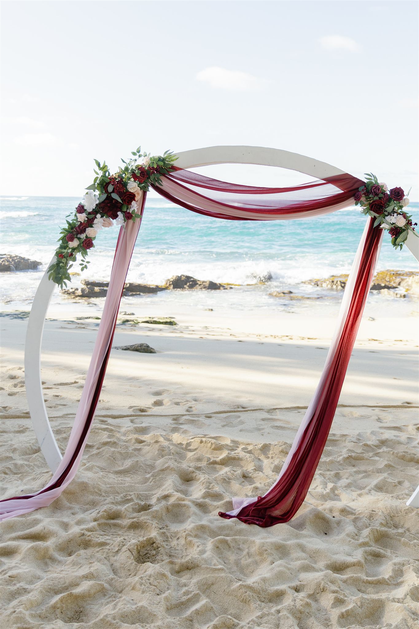 a wedding arch set up for a wedding ceremony next to the ocean at Ritz-Carlton O'ahu, Turtle Bay