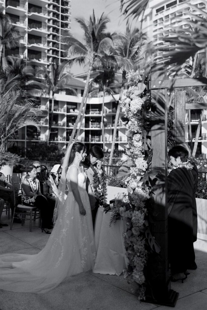 Newlyweds holding hands as they stand together for their wedding ceremony 