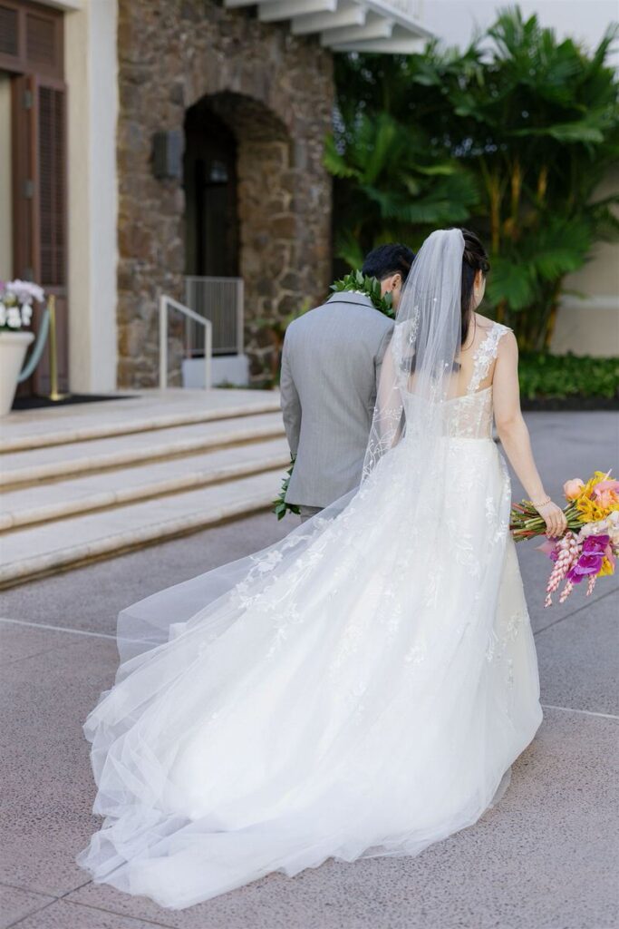Newlyweds holding hands as they walk together 