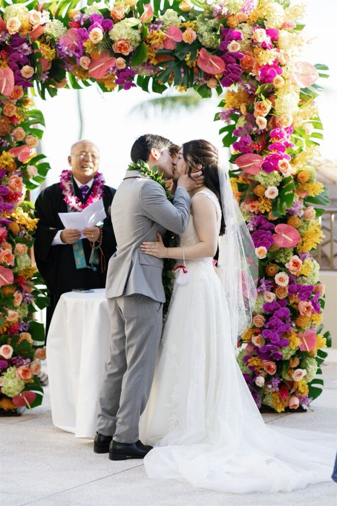 Newlyweds during their first kiss at their wedding 