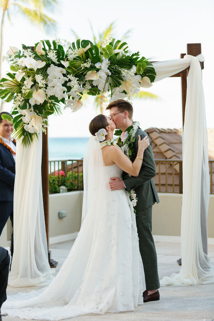Newlyweds during their first kiss at their wedding 