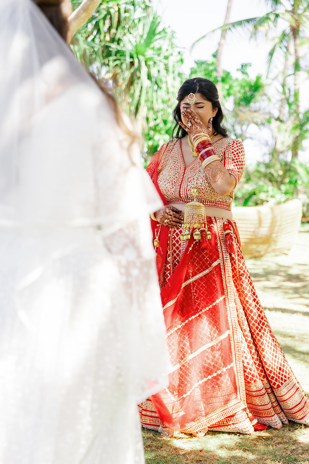 two women sharing a first look on the day of their wedding at  the Four Seasons Resort on Oahu