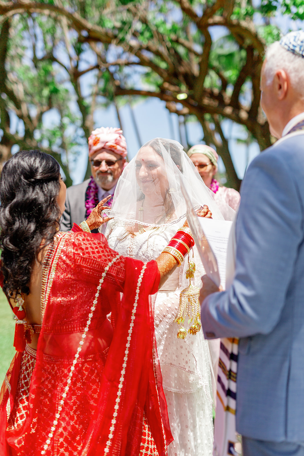two women having a multicultural wedding at  the Four Seasons Resort on Oahu
