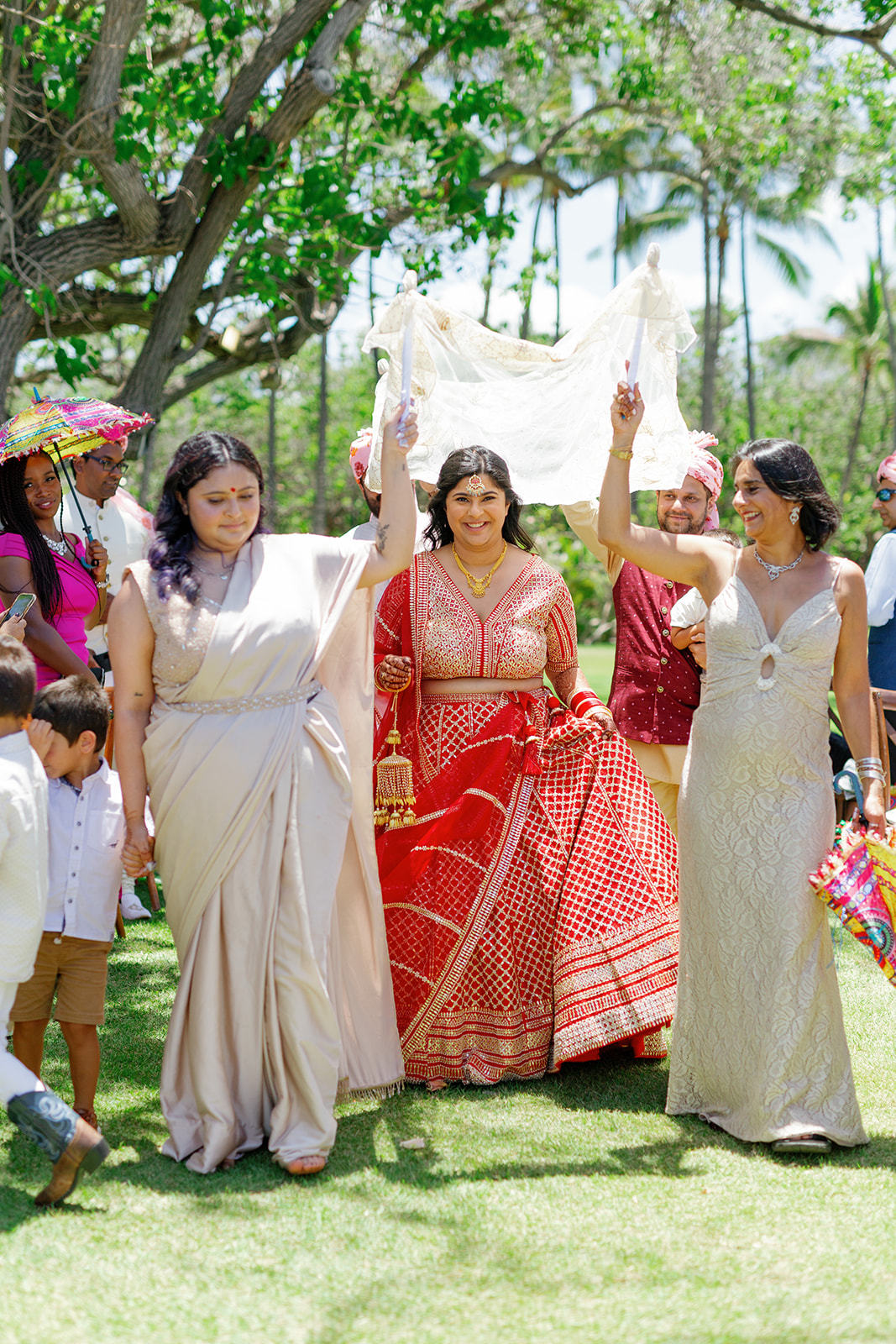 a woman walking down the grass at  the Four Seasons Resort on Oahu for her wedding ceremony