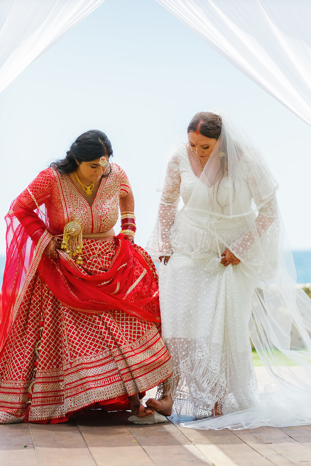 two women having a jewish wedding ceremony at  the Four Seasons Resort on Oahu