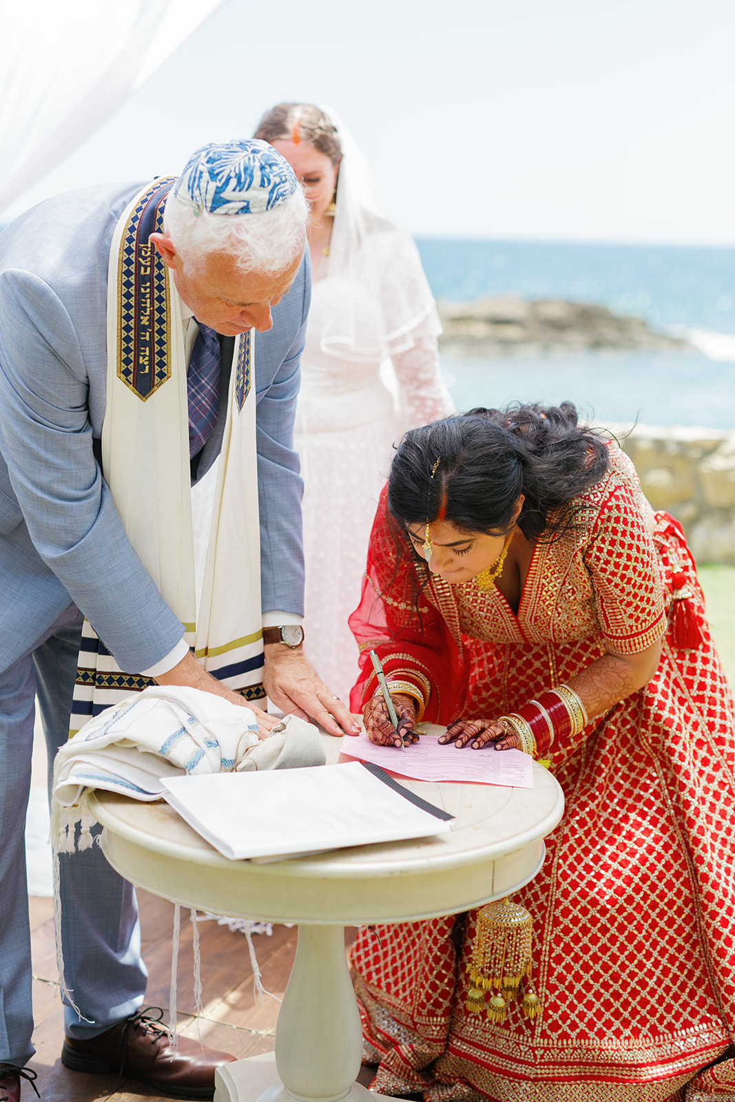 a woman signing a piece of paper during her wedding ceremony 