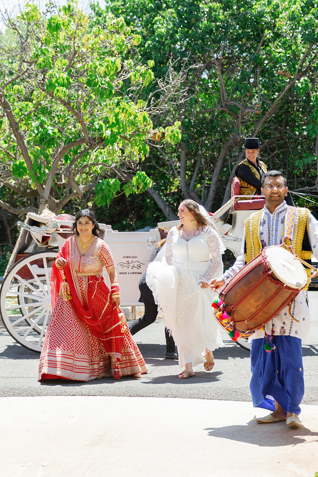 two women exiting a horse drawn carriage on the day of their wedding 