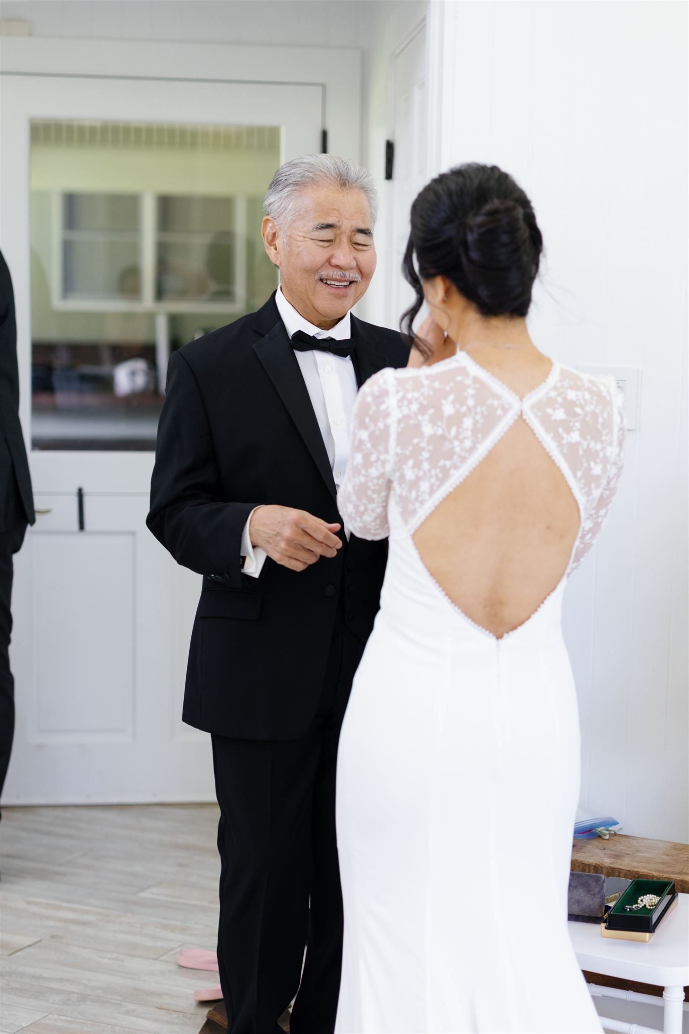 a bride sharing an emotional first look with her father