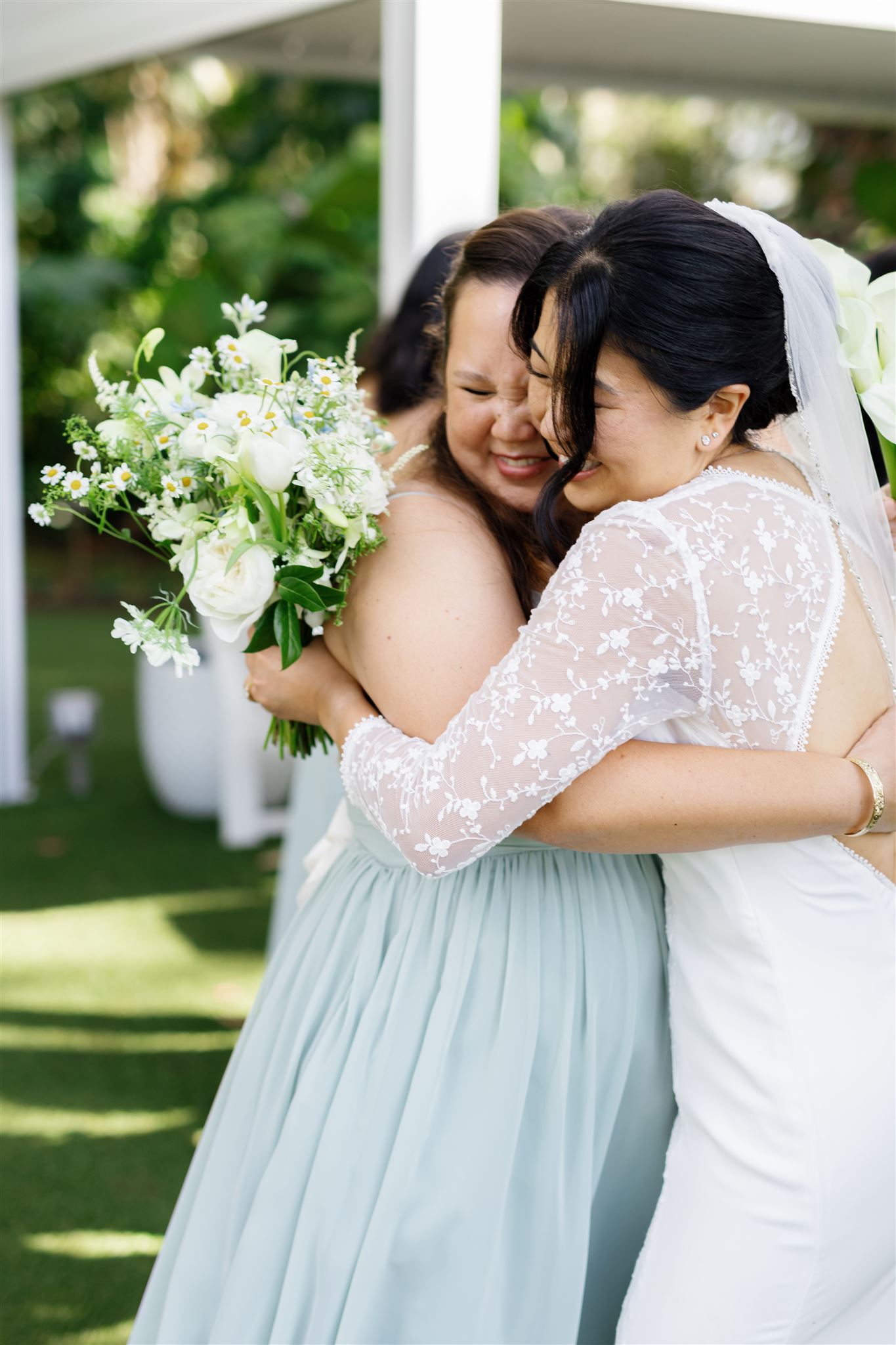 a bride hugging a bridesmaid 