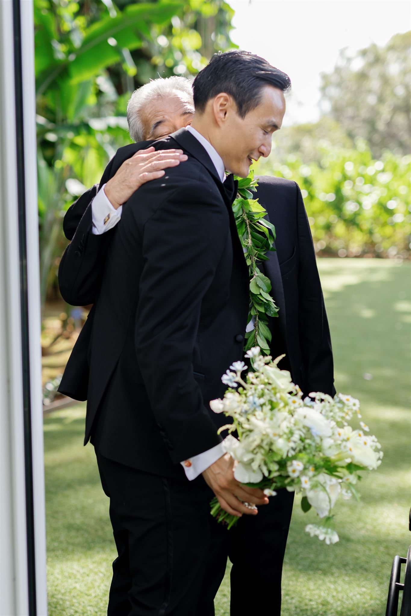 a groom hugging his bride's father 