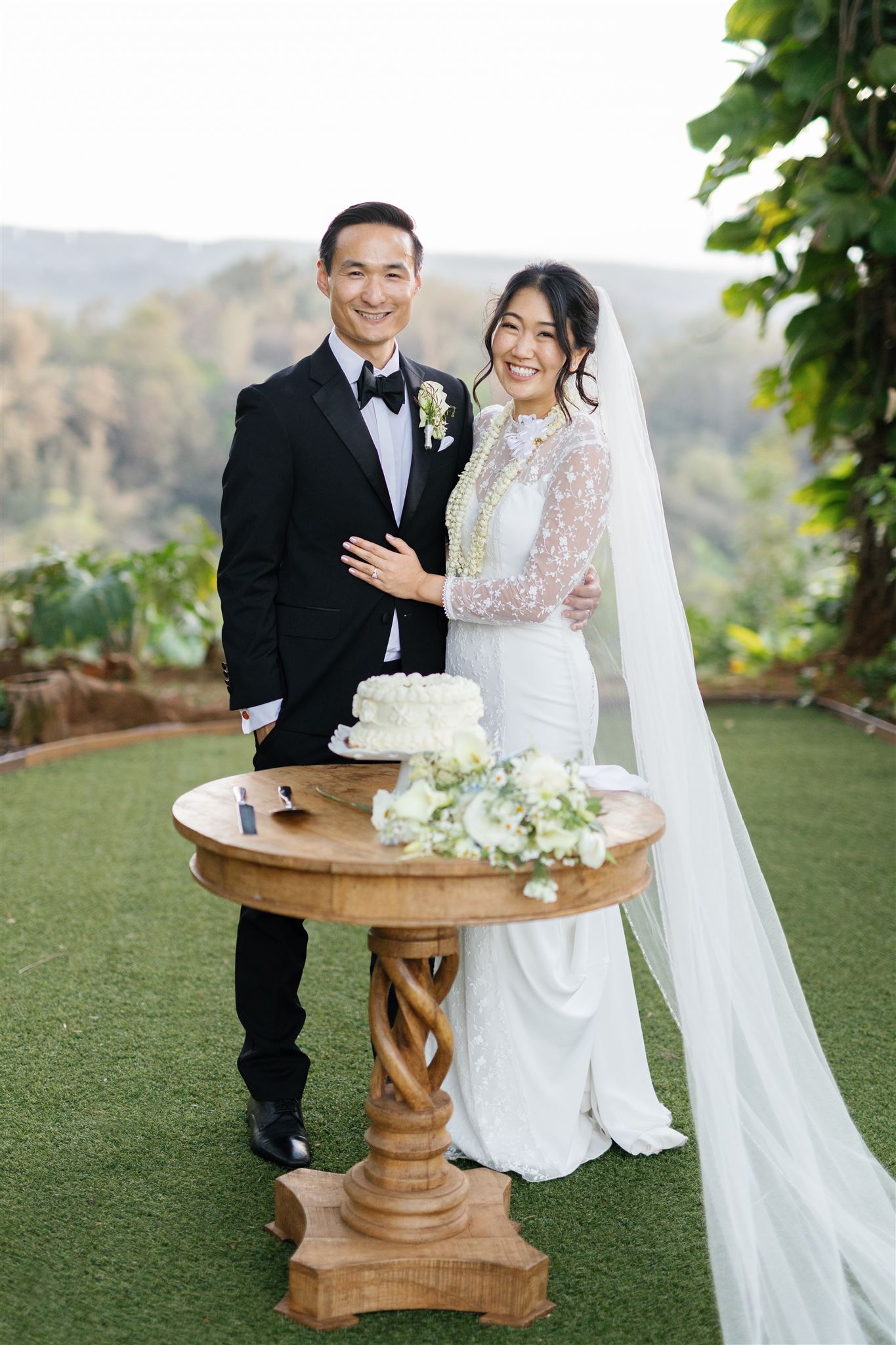 a husband and wife enjoying a private cake cutting together in fern's garden at sunset ranch after their wedding ceremony