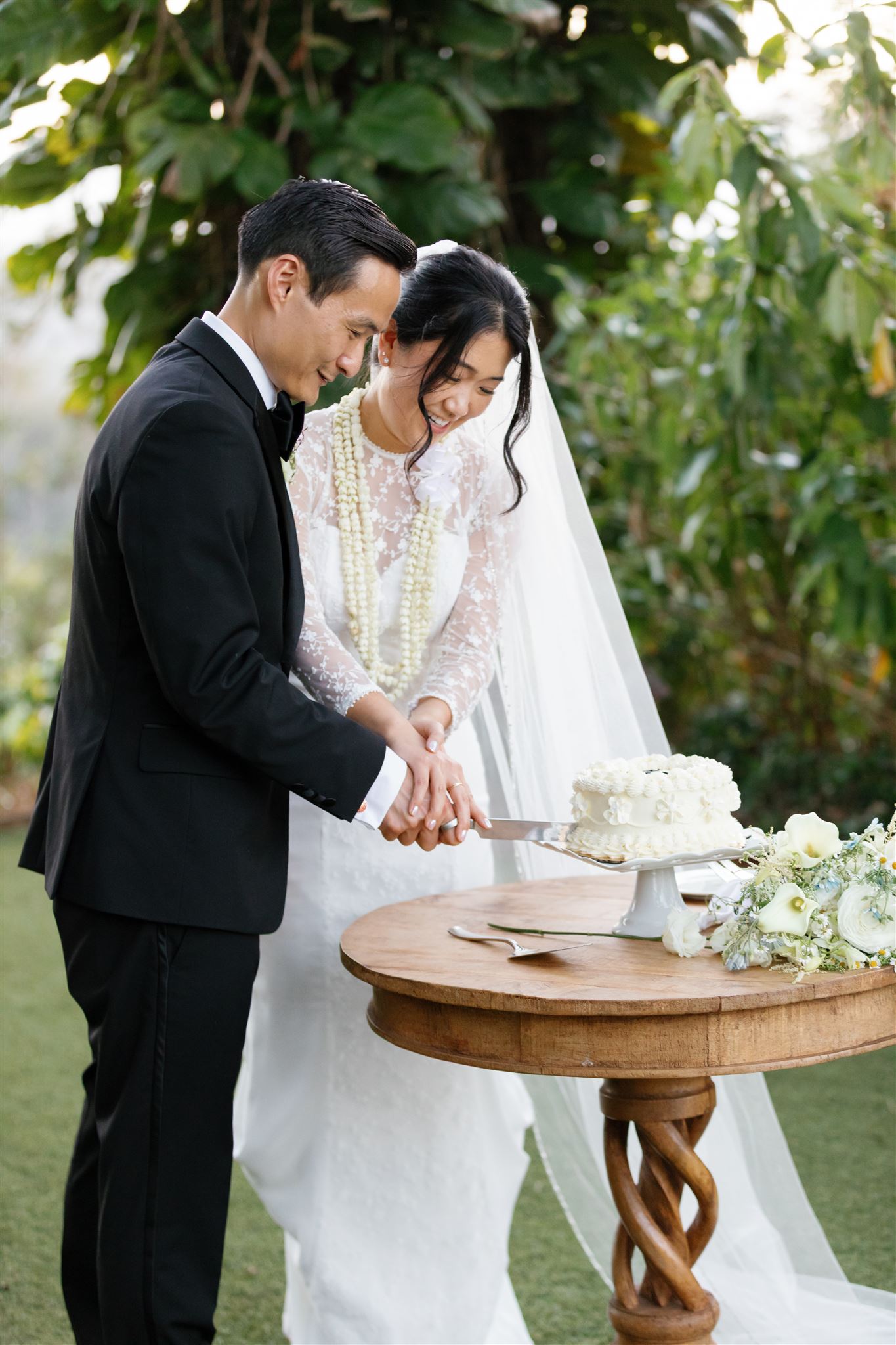a husband and wife enjoying a private cake cutting together in fern's garden at sunset ranch after their wedding ceremony