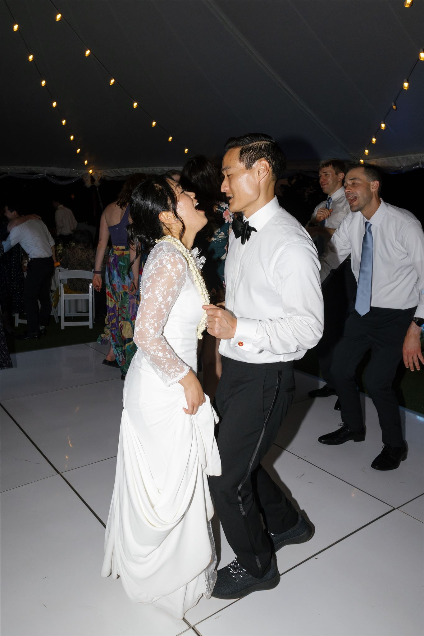 a bride and groom dancing together under a tent at their wedding reception 