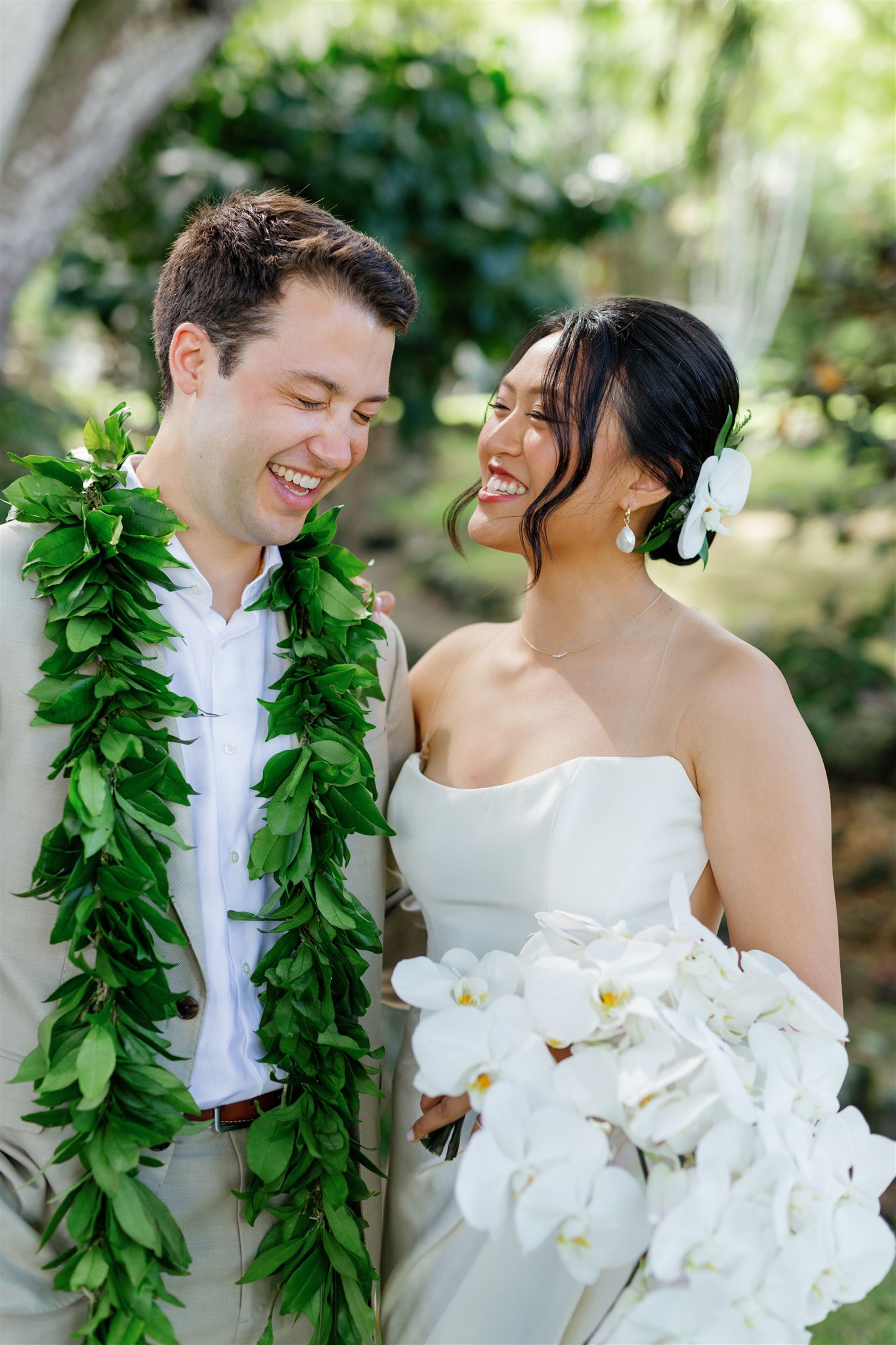 a bride and groom laughing with each other 