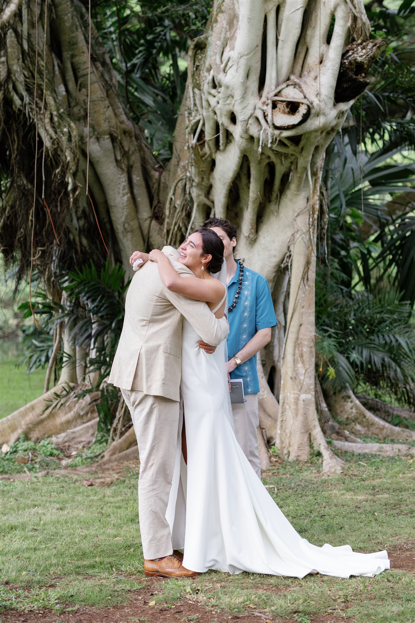 a bride and groom tearfully embracing at their wedding ceremony