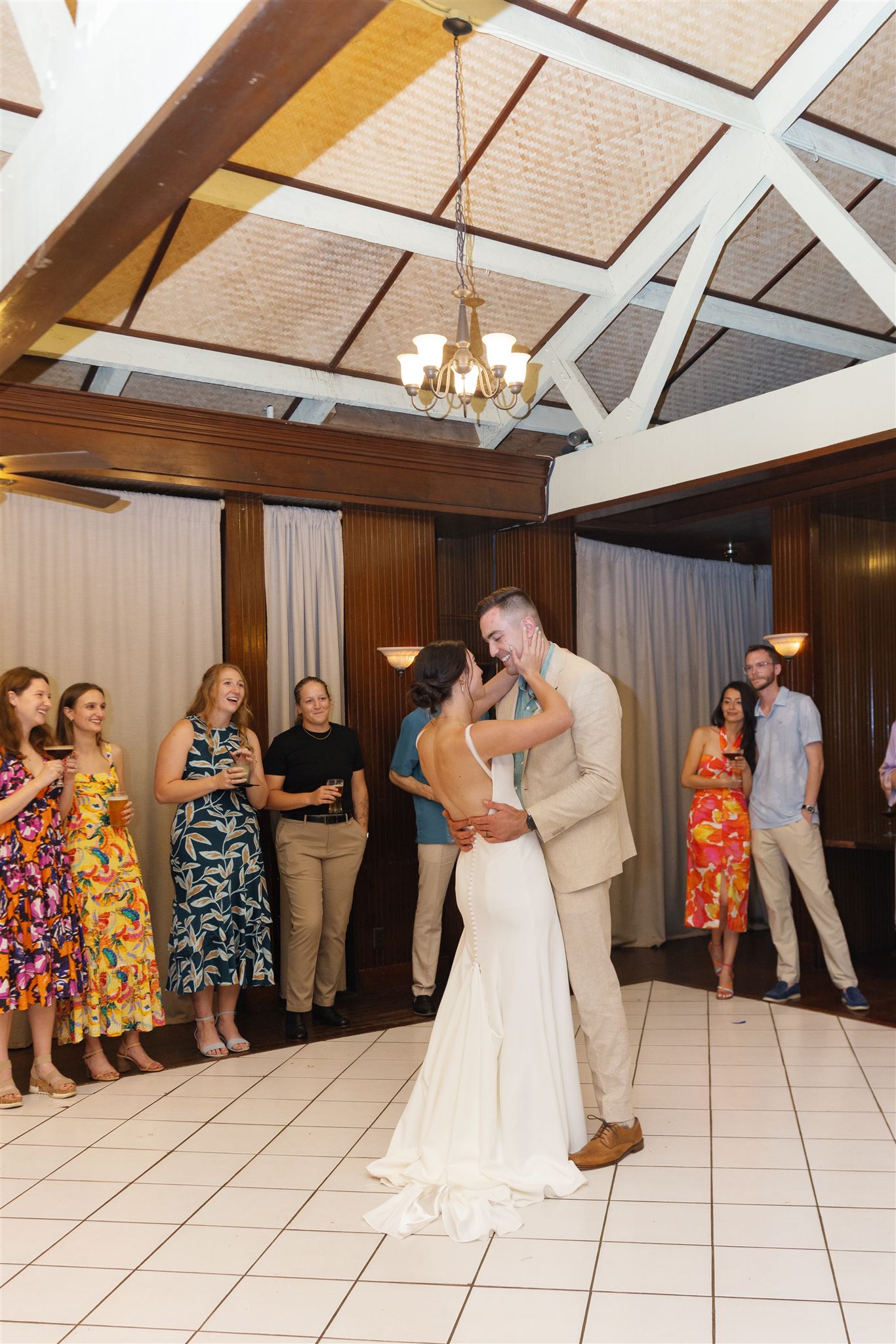 a bride and groom sharing their first dance at the proud peacock in waimea valley