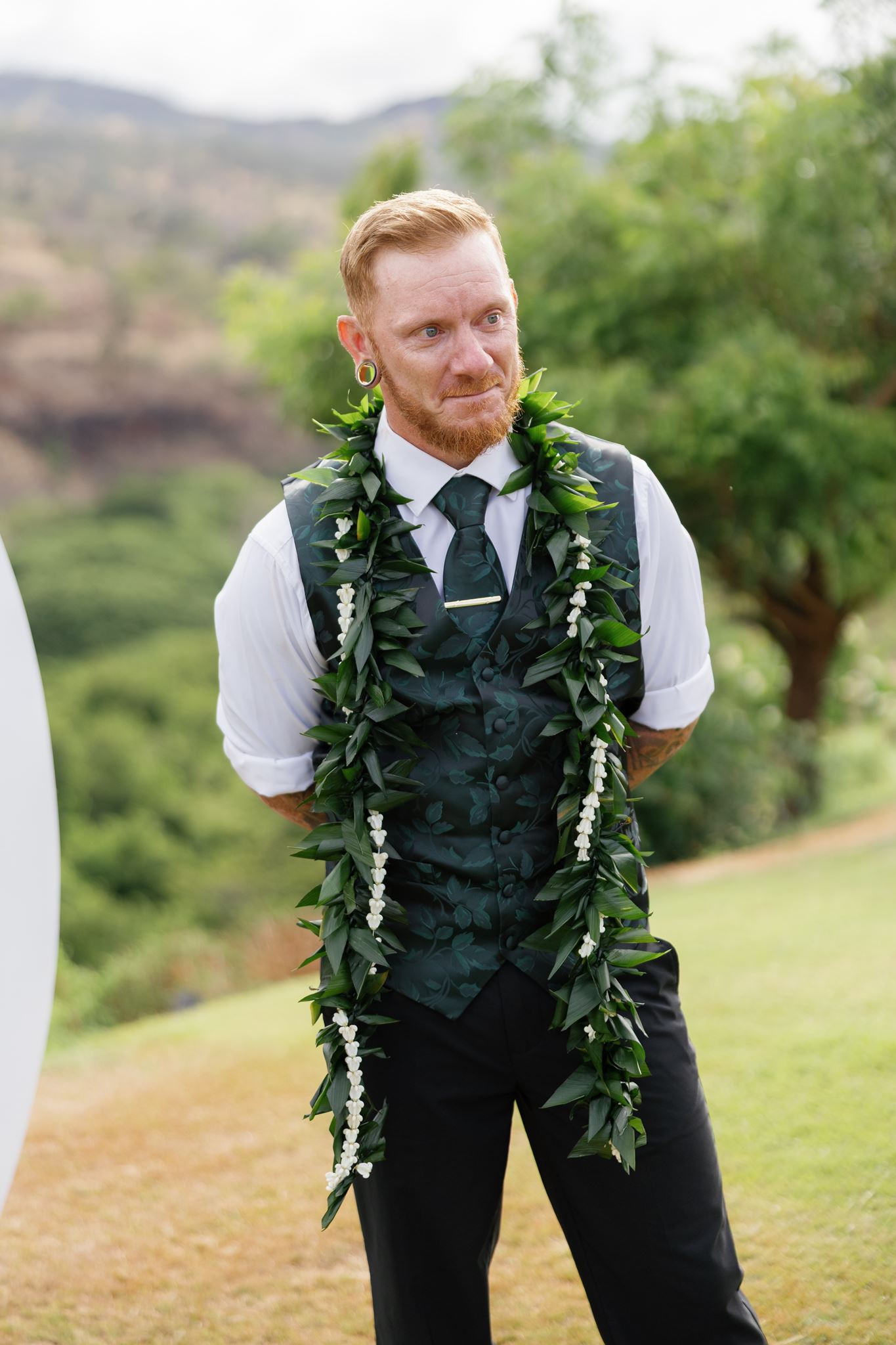 a groom getting emotional seeing his bride walk down the aisle for the first time on their wedding day