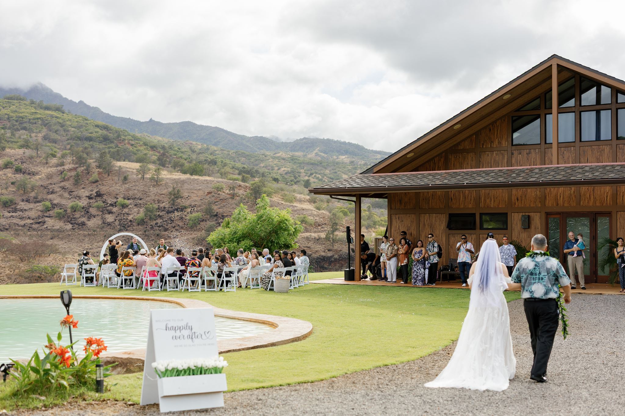 a bride walking down the aisle arm in arm with her father