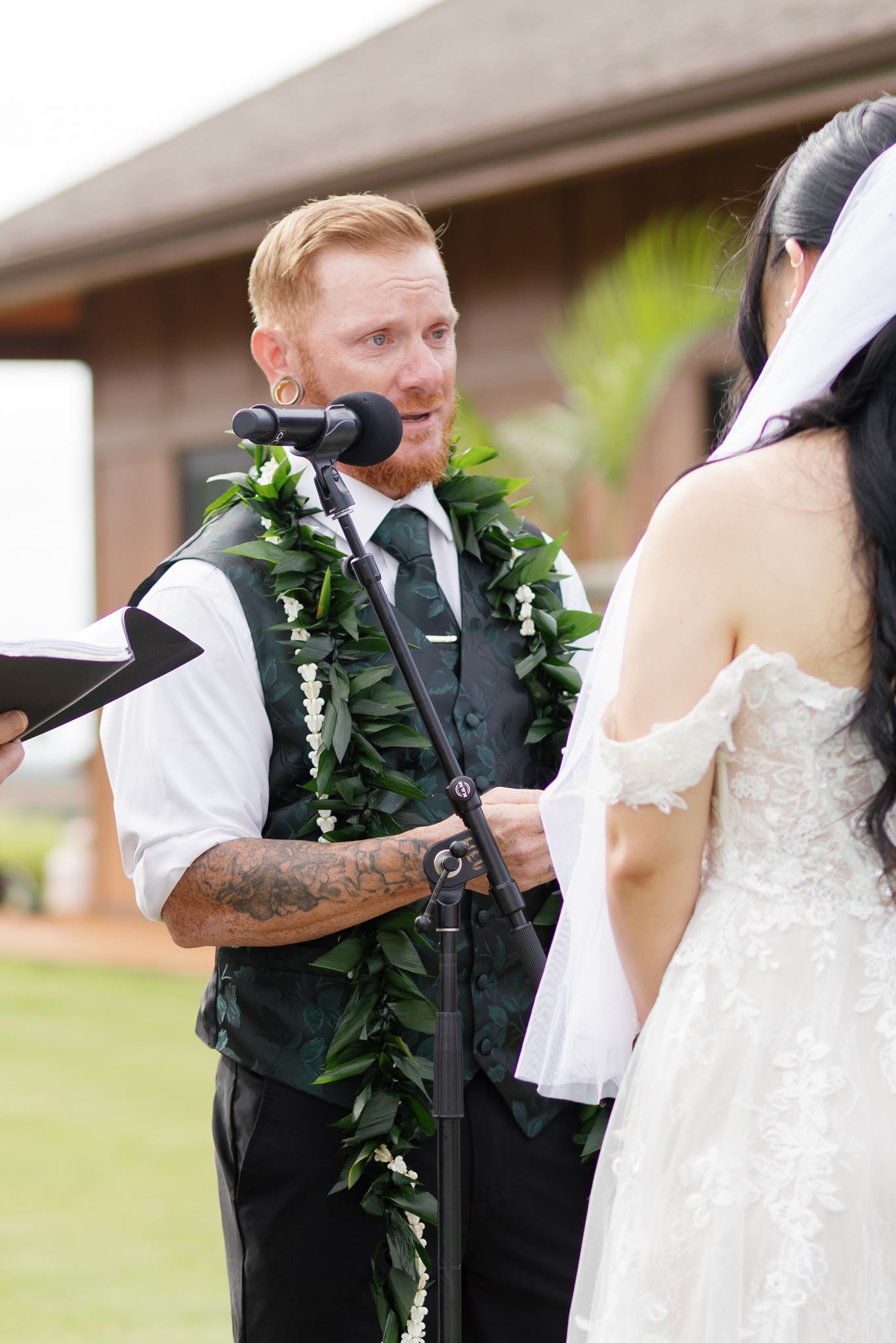 a groom reading vows to his bride during their wedding ceremony