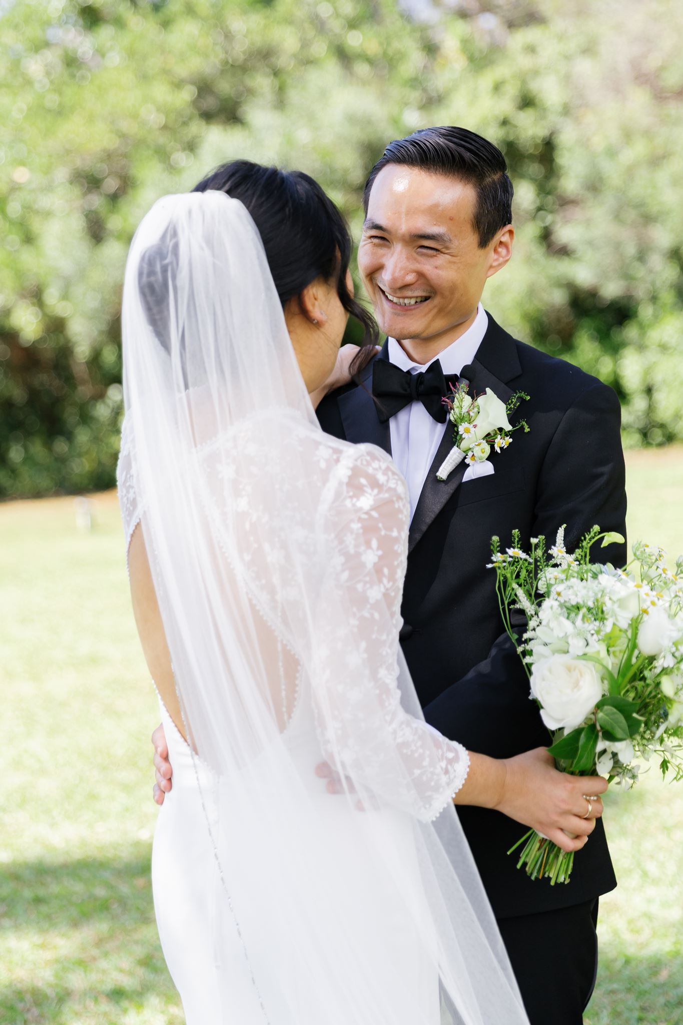 a bride and groom taking wedding portraits in a field