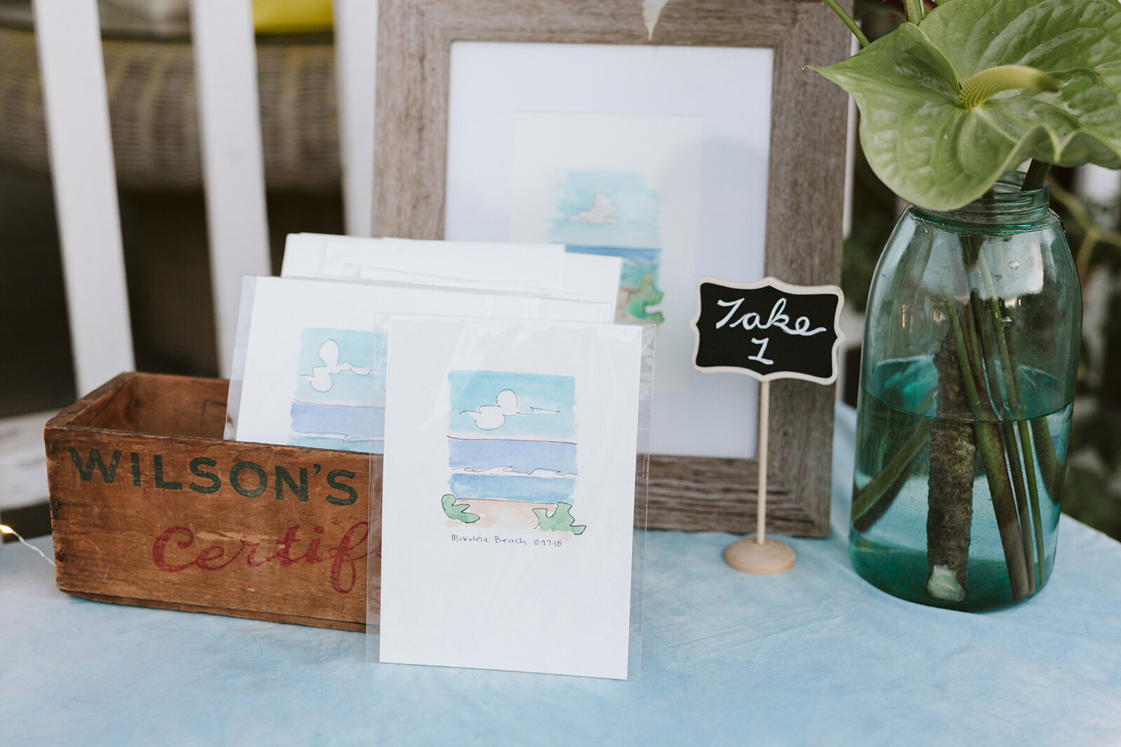 “The Bride painted these little cards herself! A little bit of the beach to take back with them. How sweet!”